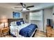 Comfortable bedroom with a decorative bedspread, wood-look floors, and a bright window for natural light at 6434 5Th W St, Bradenton, FL 34207