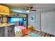 Bedroom features a twin bunk bed, wood floors, ceiling fan, and an orange and blue comforter at 6434 5Th W St, Bradenton, FL 34207