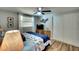 Serene bedroom with neutral tones, wood floors, and a spacious closet for ample storage at 6434 5Th W St, Bradenton, FL 34207
