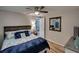 Comfortable bedroom with coastal decor, a ceiling fan, and a modern mirror at 6434 5Th W St, Bradenton, FL 34207