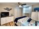 Bright bedroom featuring a ceiling fan, a spacious closet, and coastal decor at 6434 5Th W St, Bradenton, FL 34207