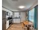Modern kitchen with stainless steel appliances, white cabinets, and an eat-in dining space at 6434 5Th W St, Bradenton, FL 34207