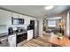 Updated kitchen with stainless steel appliances and sleek cabinetry, seamlessly connecting to the living room at 6434 5Th W St, Bradenton, FL 34207