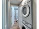 A convenient laundry room with a stacked washer and dryer setup, and adjacent bathroom at 6434 5Th W St, Bradenton, FL 34207