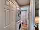 Convenient laundry area with stackable washer and dryer, located near a tastefully decorated bathroom at 6434 5Th W St, Bradenton, FL 34207
