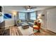 Cozy living room with gray sectional, wood floors, a white rug, and updated lighting at 6434 5Th W St, Bradenton, FL 34207