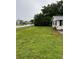 View of the home's expansive front yard showing the corner lot location and street view at 6434 5Th W St, Bradenton, FL 34207