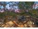 Outdoor backyard deck seating area at sunset with tropical foliage, outdoor furniture, and a relaxing atmosphere at 700 Tropical Cir, Sarasota, FL 34242