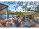 Outdoor backyard deck seating area with tropical foliage, outdoor furniture, and a relaxing atmosphere at 700 Tropical Cir, Sarasota, FL 34242
