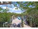 Tranquil waterfront view from a private dock with cozy seating and clear blue skies at 700 Tropical Cir, Sarasota, FL 34242