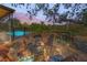 The outdoor deck features comfortable seating and an inviting fire pit with views of the pool and lush greenery at 700 Tropical Cir, Sarasota, FL 34242
