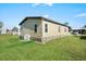 Back exterior of home showcasing well-maintained lawn and easy access to neighborhood amenities at 709 Riverview Cir, North Port, FL 34287