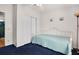 Cozy bedroom featuring blue carpet, a daybed, and a closet for storage at 709 Riverview Cir, North Port, FL 34287