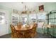 Charming dining area featuring a wooden table and chairs with lots of natural light at 709 Riverview Cir, North Port, FL 34287