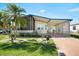 Charming single-story home with a covered carport, screened porch, and well-maintained landscaping at 709 Riverview Cir, North Port, FL 34287