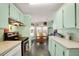 Functional kitchen with tile floors, and a view into the adjacent dining area at 709 Riverview Cir, North Port, FL 34287