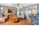 Spacious living room with ample seating, wood floors, and plenty of natural light at 709 Riverview Cir, North Port, FL 34287