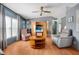 Comfortable living room featuring ample seating, hardwood floors, and a ceiling fan at 709 Riverview Cir, North Port, FL 34287