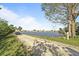Golf cart rides on this lakefront community showing the peaceful pond and gravel path at 709 Riverview Cir, North Port, FL 34287