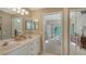 Bathroom boasts double sinks, expansive mirror, and ensuite access to the bedroom and walk in shower at 7609 Sweetbay Cir # 7609, Bradenton, FL 34203