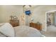 Serene bedroom featuring neutral tones, wood furniture, and ensuite access to the bathroom at 7609 Sweetbay Cir # 7609, Bradenton, FL 34203