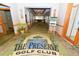 Elegant clubhouse foyer featuring decorative flooring, signage, and a glimpse into the dining area at 7609 Sweetbay Cir # 7609, Bradenton, FL 34203