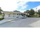 Charming clubhouse exterior with a welcoming porch and a convenient golf cart parking area at 7609 Sweetbay Cir # 7609, Bradenton, FL 34203