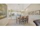 Bright dining area featuring an elegant chandelier and an open layout that leads to the kitchen at 7609 Sweetbay Cir # 7609, Bradenton, FL 34203