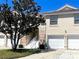 Two-story townhome features an attached garage and well-manicured landscaping at 7609 Sweetbay Cir # 7609, Bradenton, FL 34203