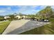 Golf course clubhouse and golf cart parking featuring a covered, two-story design with manicured landscaping at 7609 Sweetbay Cir # 7609, Bradenton, FL 34203