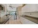 Bright kitchen featuring white cabinets, stainless steel appliances, and a soaring ceiling at 7609 Sweetbay Cir # 7609, Bradenton, FL 34203