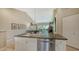 Open kitchen with stainless steel appliances, a breakfast bar, and seamless flow to the living area at 7609 Sweetbay Cir # 7609, Bradenton, FL 34203