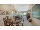 Open-concept living area with elegant chandelier and comfortable seating at 7609 Sweetbay Cir # 7609, Bradenton, FL 34203