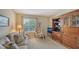 Comfortable living room featuring a plush sofa, floral chair, and a large wooden entertainment center at 7609 Sweetbay Cir # 7609, Bradenton, FL 34203