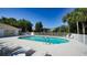 Inviting community pool with lounge chairs surrounded by lush landscaping under a clear blue sky at 7609 Sweetbay Cir # 7609, Bradenton, FL 34203