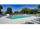Inviting community pool with lounge chairs surrounded by lush landscaping under a clear blue sky at 7609 Sweetbay Cir # 7609, Bradenton, FL 34203