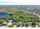 Aerial view of property and neighborhood with mature trees and bodies of water nearby at 8036 Conservatory Cir, Sarasota, FL 34243