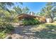 Screened in porch on home surrounded by lush landscaping, providing privacy and a connection to nature at 8036 Conservatory Cir, Sarasota, FL 34243