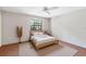 Bright bedroom featuring a ceiling fan, neutral decor, and a large picture window at 8036 Conservatory Cir, Sarasota, FL 34243