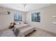 Comfortable bedroom with a ceiling fan, natural light, and neutral decor at 8036 Conservatory Cir, Sarasota, FL 34243