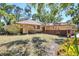 Charming home with a well-maintained front yard, wood fence, and lush landscaping at 8036 Conservatory Cir, Sarasota, FL 34243