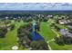 Expansive golf course with a meandering waterway and lush green landscaping, all under a picturesque sky at 8036 Conservatory Cir, Sarasota, FL 34243