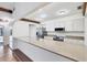 Well-lit kitchen boasting a large island, stainless steel appliances, and white cabinetry at 8036 Conservatory Cir, Sarasota, FL 34243