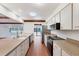 Modern kitchen with stainless steel appliances, long countertops, and an open floor plan at 8036 Conservatory Cir, Sarasota, FL 34243