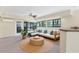 Cozy sunroom with comfortable seating, large windows, and a ceiling fan at 8036 Conservatory Cir, Sarasota, FL 34243