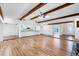 Bright living room with hardwood floors, exposed beams, and an open-concept kitchen at 8036 Conservatory Cir, Sarasota, FL 34243