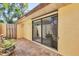 Enclosed patio with brick flooring, garden views, and a sliding glass door leading inside at 8036 Conservatory Cir, Sarasota, FL 34243