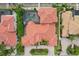 Aerial view of home showcasing its tile roof, screened-in pool, and waterfront location at 805 3Rd E St, Palmetto, FL 34221