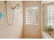 Walk-in shower with glass block window and a multi-setting shower head at 805 3Rd E St, Palmetto, FL 34221