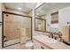 Well-lit bathroom featuring earth tone tiles in shower and flooring plus a large mirror above the vanity at 805 3Rd E St, Palmetto, FL 34221